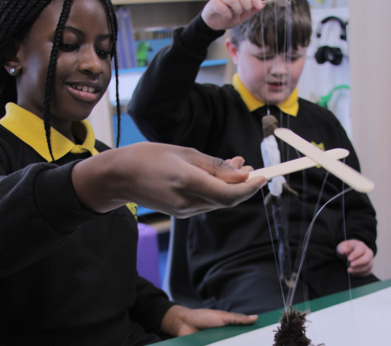 Children learning to master puppetry