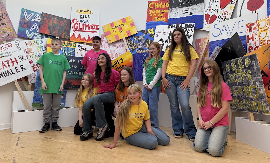 Child Human Rights Defenders pose infront of the Talbot Rice Gallery exhibit.