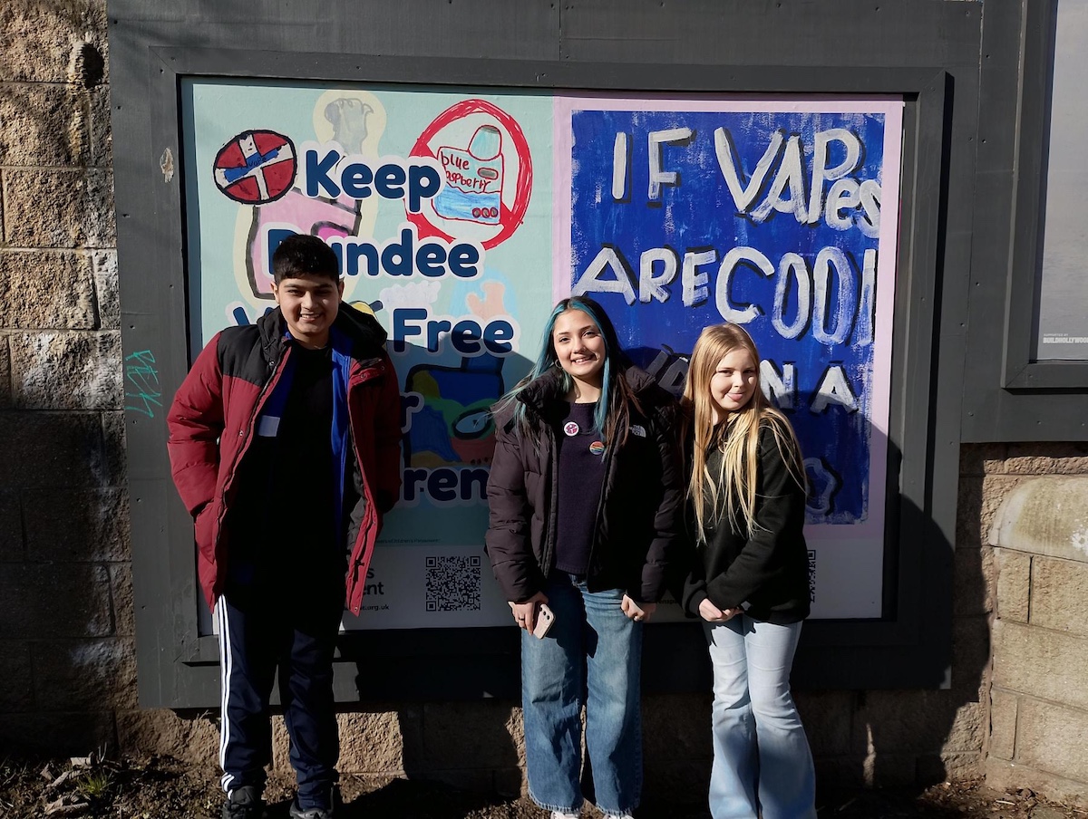 Members of Children's Parliament with one of their bill boards in Dundee.