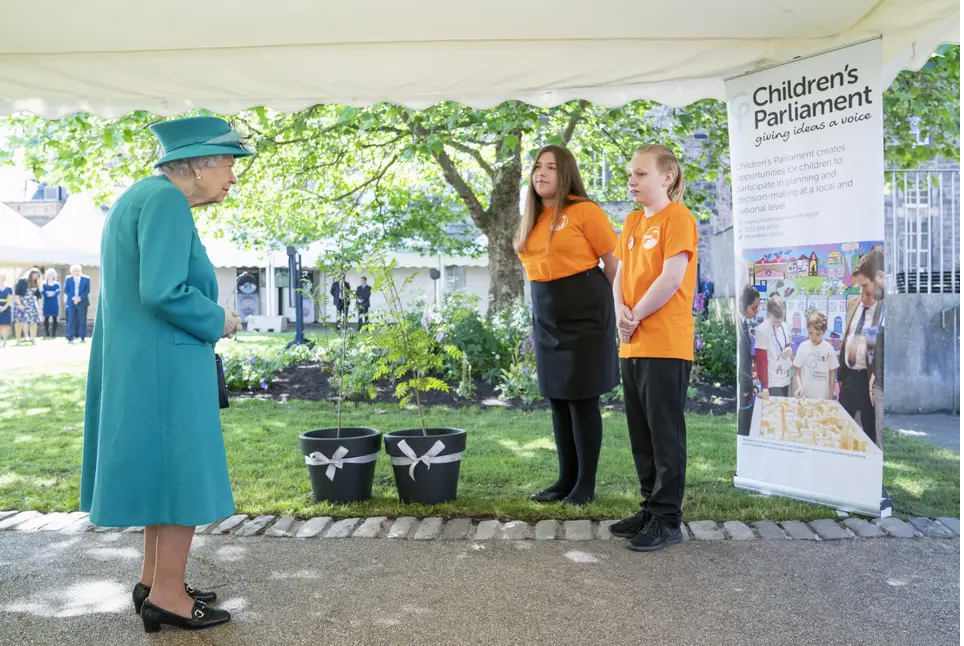 Members of Children's Parliament present two trees to the late Queen during a Scottish Parliament visit in 2021.