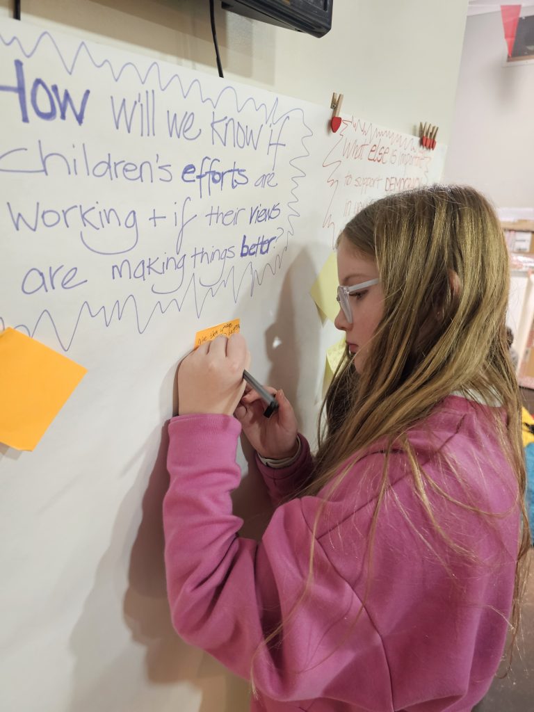 Democracy Matters Member of Children's Parliament writing her ideas