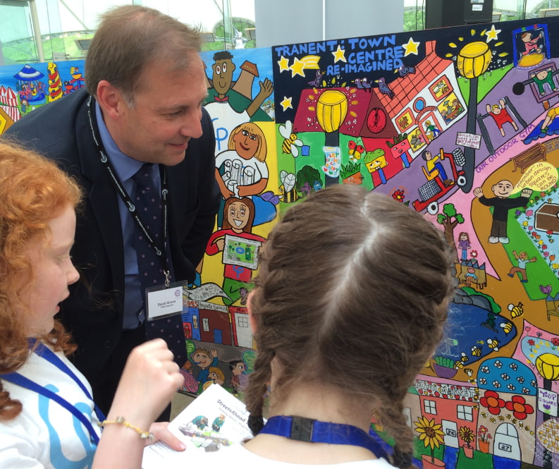 Children proudly showing their work of a re-imagined town centre